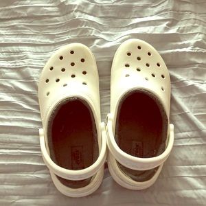 White fur lined crocs.